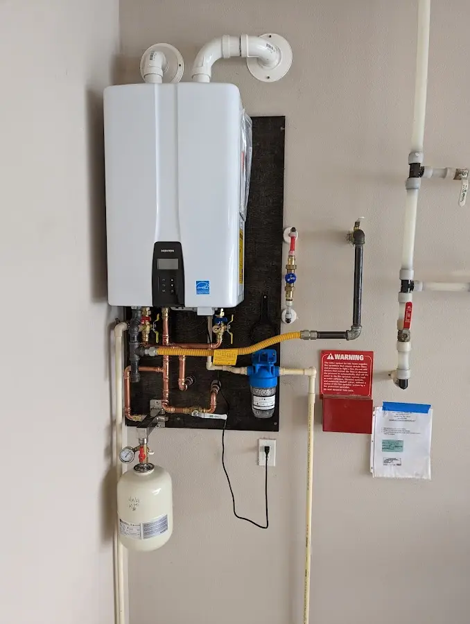 Professional plumber installing copper piping in a River Vale home